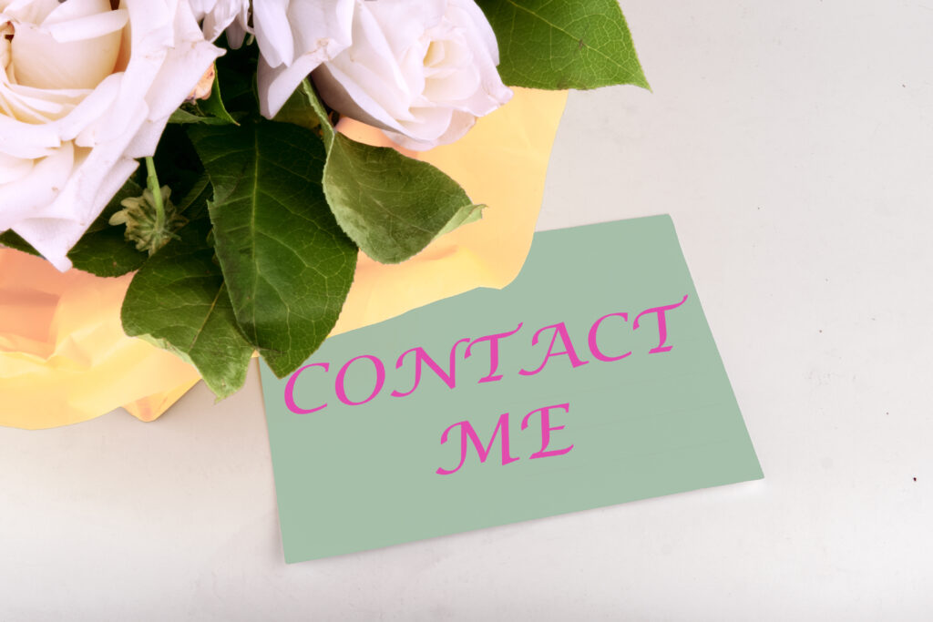 Customer Service Support Concept. CONTACT ME words on a piece of paper near a bouquet of flowers